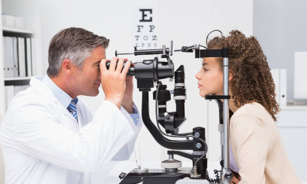 Woman getting an eye exam from an optometrist