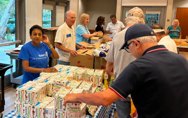 Mission Viejo Rotary Club members distribute packaged foods at a local food bank