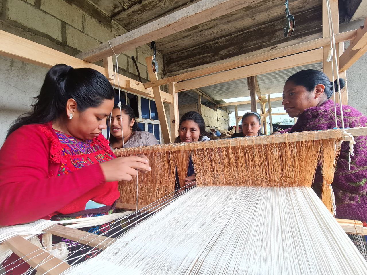 Mam women weave traditional Guatemalan fabrics.