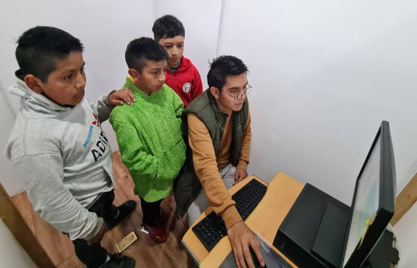 Guatemalan boys learn computer skills.
